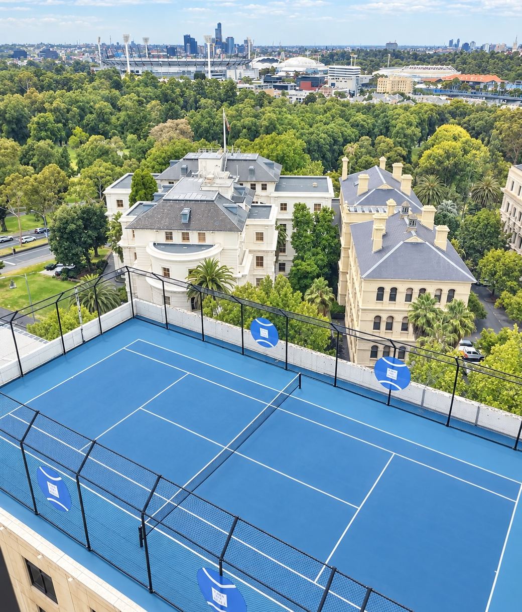 The rooftop tennis court at Park Hyatt Melbourne, the parkland, the MCG and the city skyline beyond